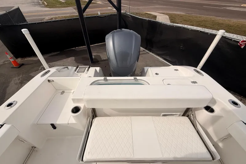 Slide: The Image of 2023 Sea Pro 239 Center Console boat interior with seating and engine view. - 73
