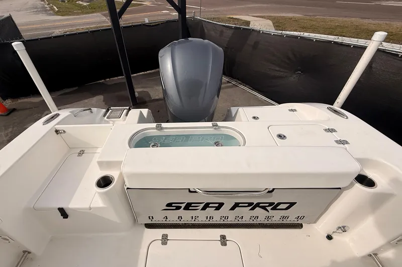 Slide: The Image of 2023 Sea Pro 239 Center Console boat with outboard motor and storage compartments. - 74