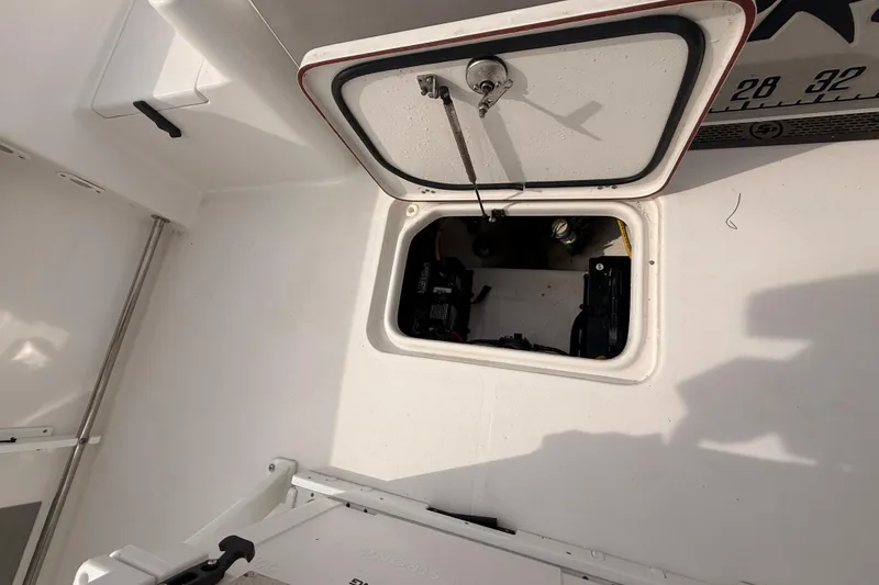 Slide: The Image of Open hatch on 2023 Sea Pro 239 Center Console boat, revealing internal compartment. - 76