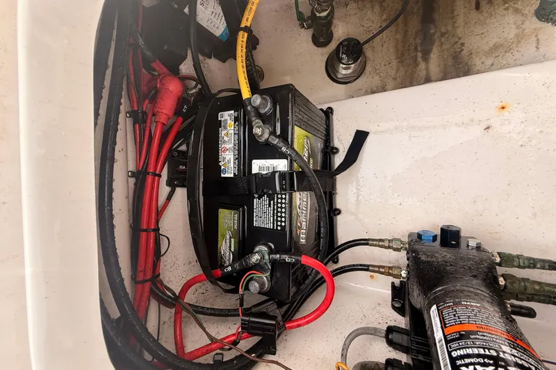 Slide: The Image of Battery compartment of 2023 Sea Pro 239 Center Console boat with wiring and components. - 78