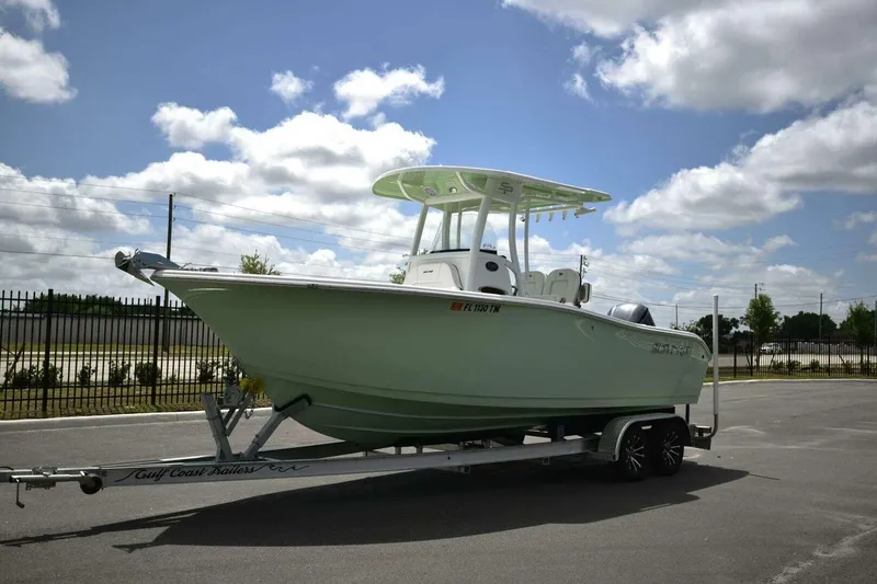 Slide: The Image of 2023 Sea Pro 239 Center Console boat on trailer, displayed outdoors. - 9