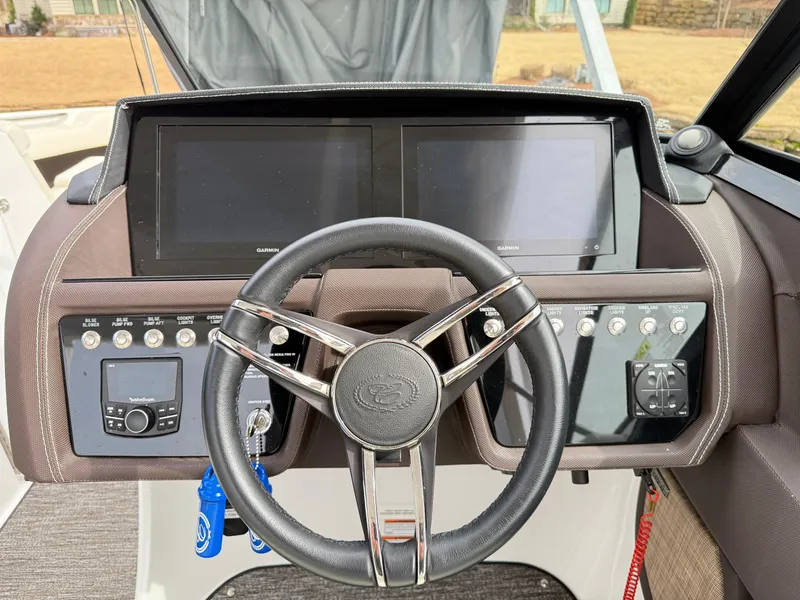 Slide: The Image of Steering wheel and dashboard of 2021 Cobalt R30 boat with dual screens and controls. - 11