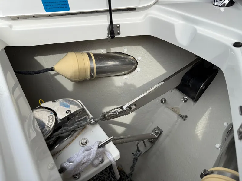 Slide: The Image of Anchor compartment of 2021 Cobalt R30 boat, featuring winch and chain storage. - 21