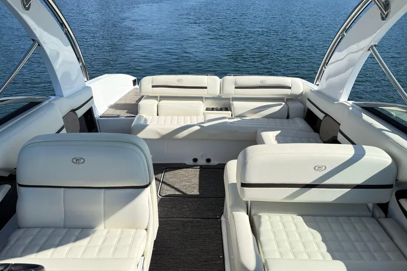 Slide: The Image of Luxurious 2021 Cobalt R30 boat interior with white seating on a serene lake. - 24