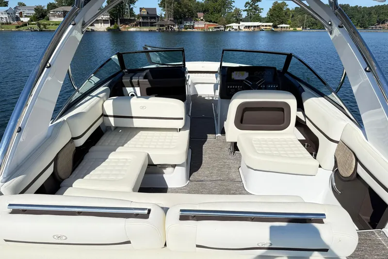 Slide: The Image of 2021 Cobalt R30 boat interior with luxurious seating on a serene lake. - 6