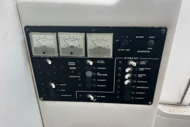 Slide: The Image of Control panel of a 1998 Pro-Line 2610 Walkaround boat with voltage meters and switches. - 11