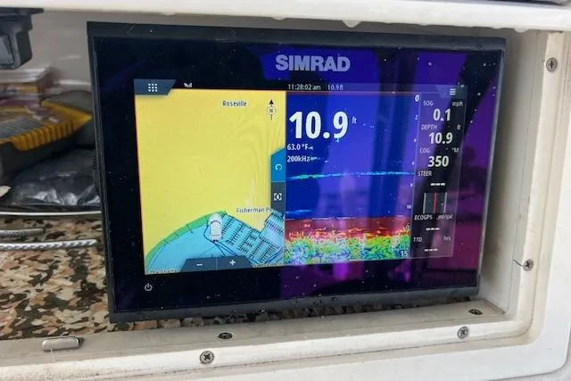 Slide: The Image of Simrad marine display on 1998 Pro-Line 2610 Walkaround showing depth and navigation data. - 15