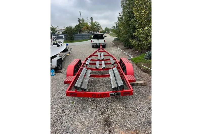 Slide: The Image of Red boat trailer for 1998 Pro-Line 2610 Walkaround on gravel driveway. - 21