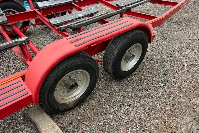 Slide: The Image of Red boat trailer for 1998 Pro-Line 2610 Walkaround on gravel surface. - 22