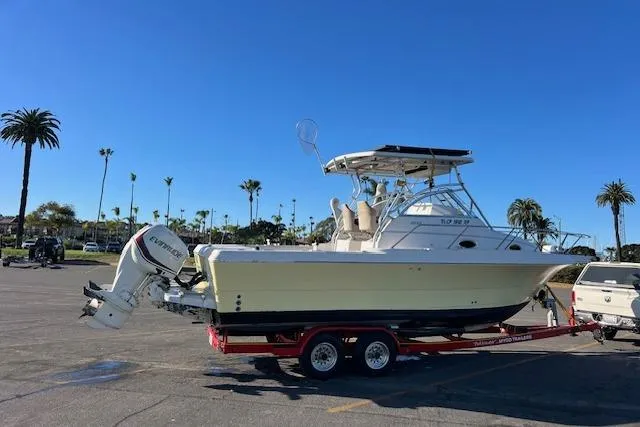 Slide: The Image of 1998 Pro-Line 2610 Walkaround boat on trailer in sunny parking lot. - 29