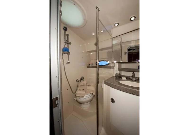 Slide: The Image of 2015 Regal 38 Express yacht docked, covered in black canvas, surrounded by other boats. - 10