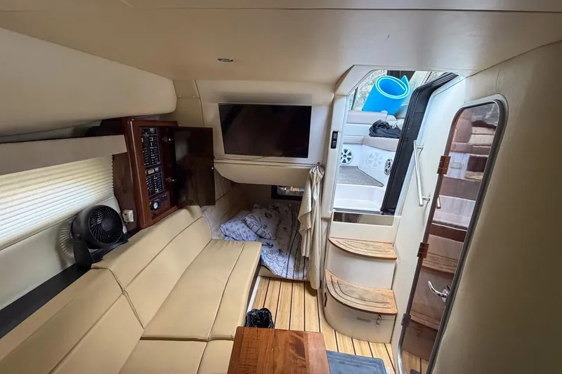 Slide: The Image of 2015 Regal 38 Express yacht kitchen with sink, microwave, and wooden cabinetry. - 100