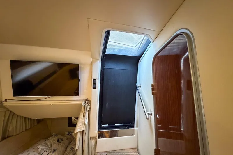Slide: The Image of 2015 Regal 38 Express cabin interior with cozy bedding and mirror. - 109