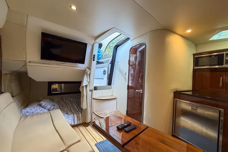 Slide: The Image of Interior of 2015 Regal 38 Express yacht with beige seating and wooden flooring. - 110