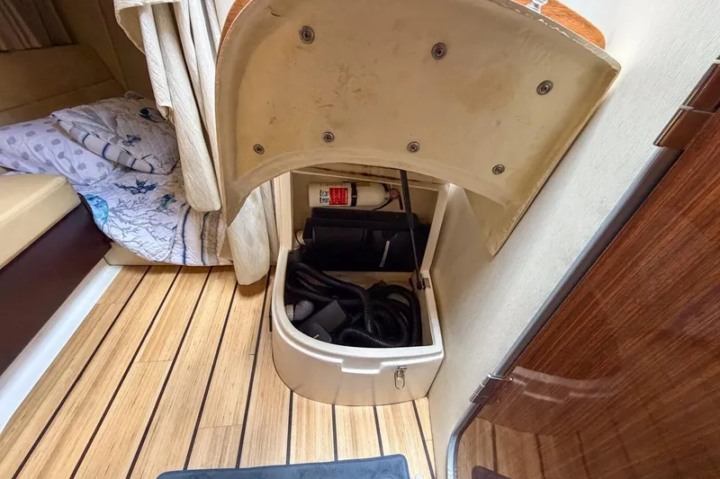 Slide: The Image of 2015 Regal 38 Express yacht interior with TV, seating, and stairs to deck. - 111