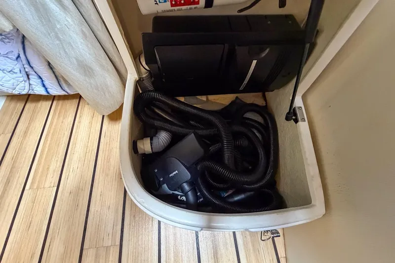 Slide: The Image of Interior of 2015 Regal 38 Express yacht with cozy seating, TV, and wooden accents. - 112