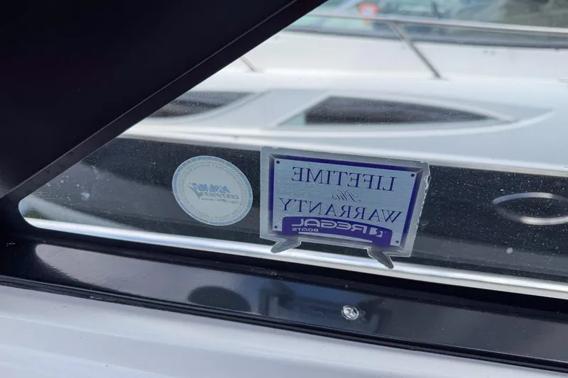 Slide: The Image of 2015 Regal 38 Express interior storage compartment with wooden flooring and cozy bedding. - 115