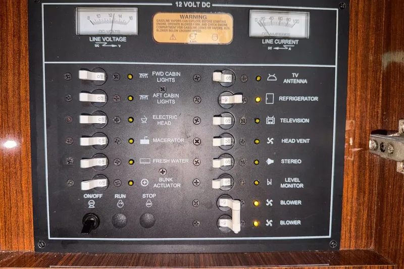 Slide: The Image of Electrical control panel of a 2015 Regal 38 Express boat with labeled switches. - 121
