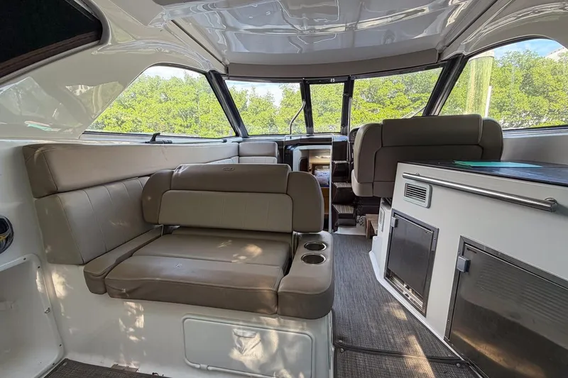 Slide: The Image of Open storage compartment on 2015 Regal 38 Express boat, filled with water sports gear. - 14