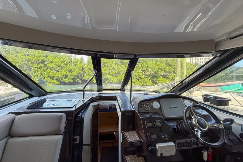Slide: The Image of Interior of 2015 Regal 38 Express yacht, featuring seating and helm station. - 19