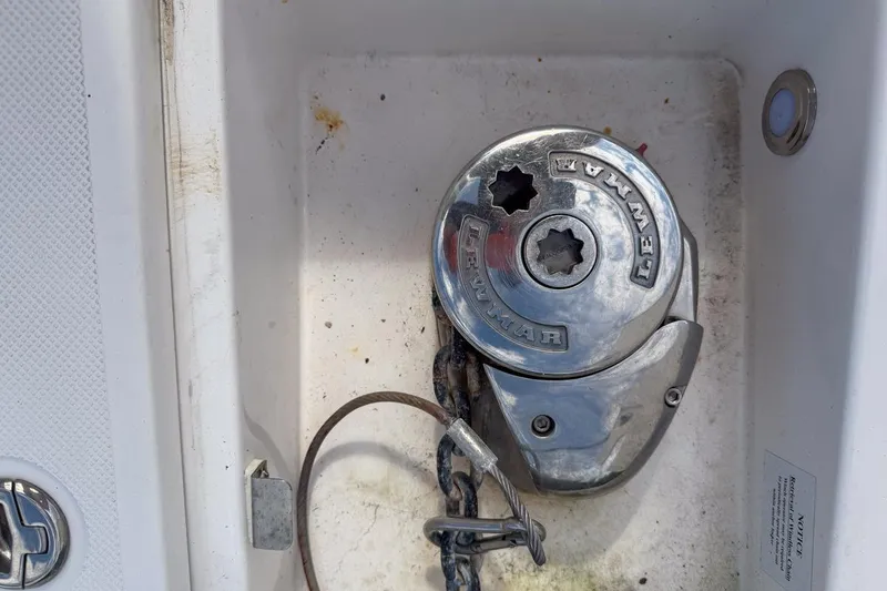 Slide: The Image of 2015 Regal 38 Express yacht bow view, docked near lush greenery. - 24