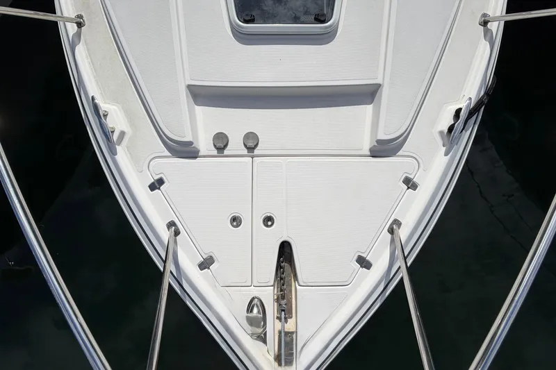 Slide: The Image of Bow view of 2015 Regal 38 Express boat on calm water reflecting trees. - 27