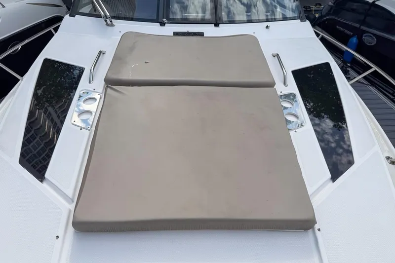 Slide: The Image of 2015 Regal 38 Express yacht docked among other boats, showcasing sleek design and spacious deck. - 35