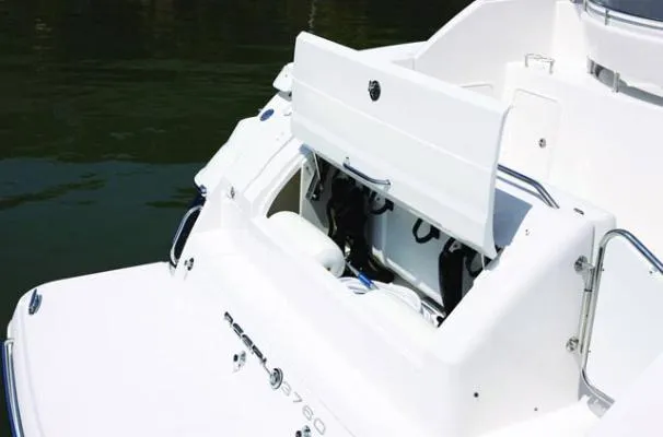 Slide: The Image of 2015 Regal 38 Express yacht docked at marina with cityscape background. - 4