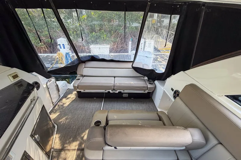 Slide: The Image of 2015 Regal 38 Express yacht with reflective windows and sleek design. - 43