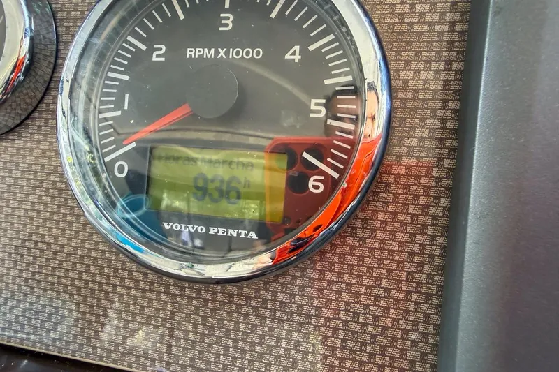 Slide: The Image of 2015 Regal 38 Express boat helm with steering wheel and control panel. - 54