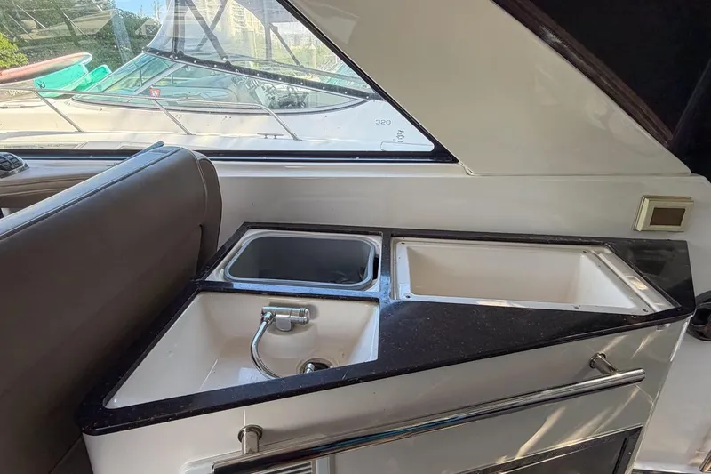Slide: The Image of Interior view of 2015 Regal 38 Express yacht with cozy seating and wooden table. - 64