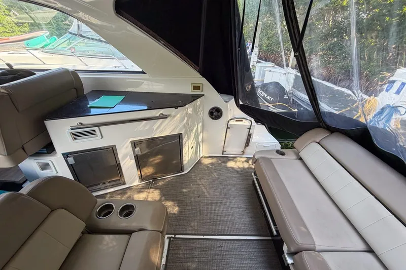 Slide: The Image of Interior of 2015 Regal 38 Express yacht with seating and control panel. - 65