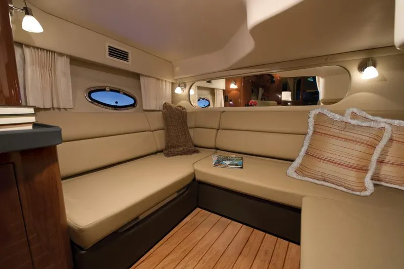 Slide: The Image of 2015 Regal 38 Express yacht docked near lush greenery and urban skyline. - 7