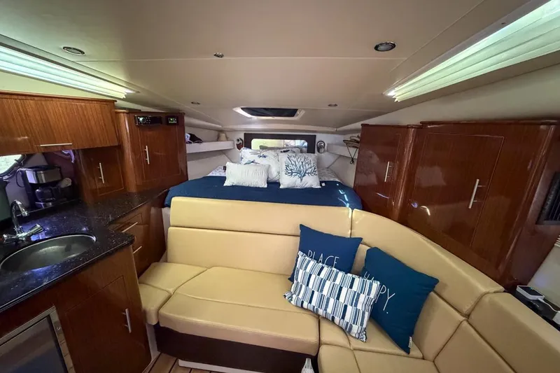 Slide: The Image of Luxurious interior of 2015 Regal 38 Express yacht with beige seating and wooden table. - 79