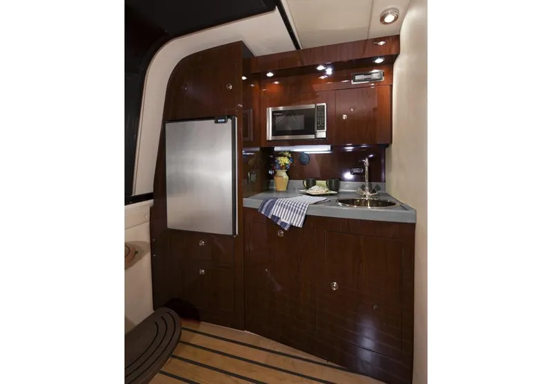 Slide: The Image of 2015 Regal 38 Express yacht docked, featuring sleek design and black cover. - 9