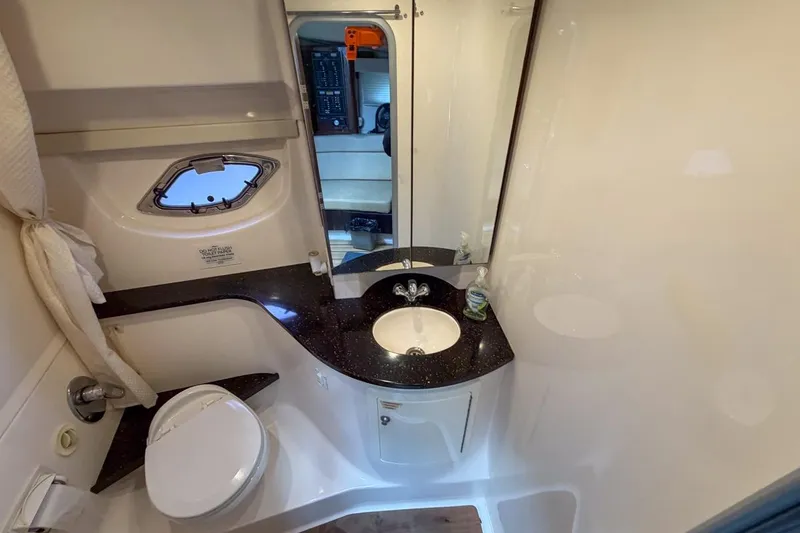 Slide: The Image of Bathroom interior of 2015 Regal 38 Express yacht with towels and toilet. - 93