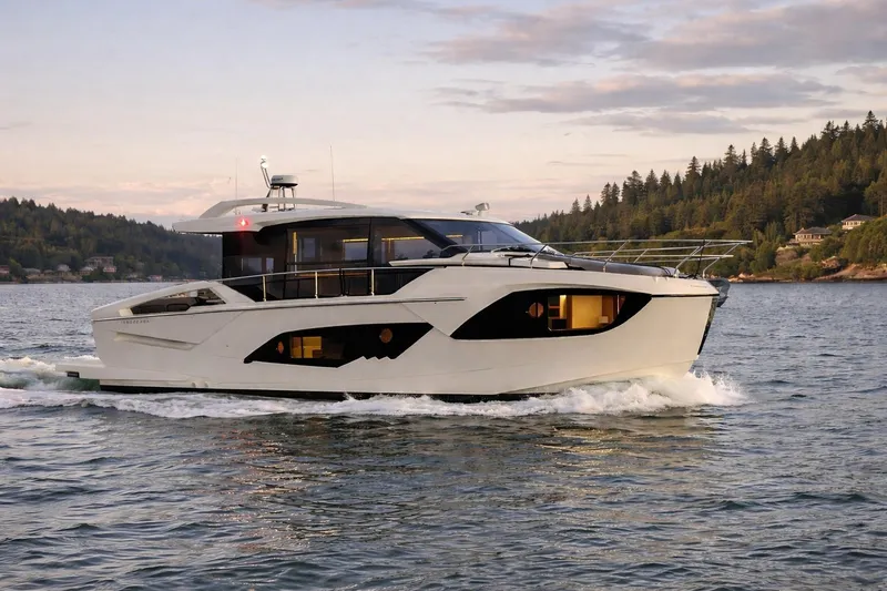 The Image of Luxury 2026 Absolute 48 Coupe yacht cruising on a scenic waterway. - 0
