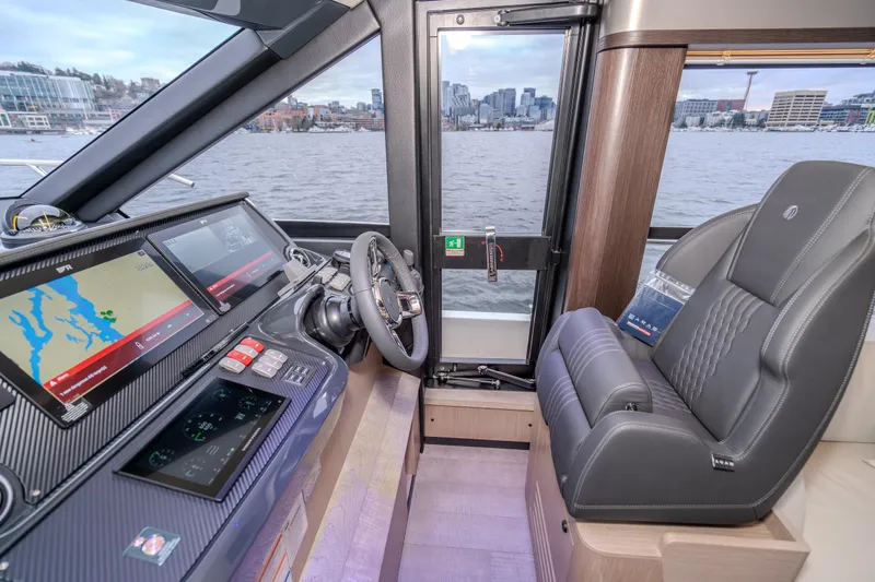 Slide: The Image of Helm of 2026 Absolute 48 Coupe yacht with advanced navigation displays and luxurious seating. - 24