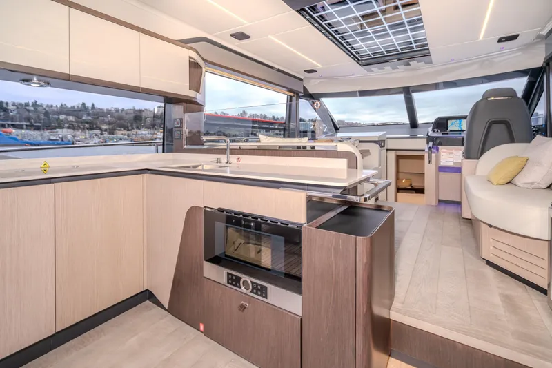 Slide: The Image of Luxurious interior of 2026 Absolute 48 Coupe yacht with modern kitchen and seating area. - 30
