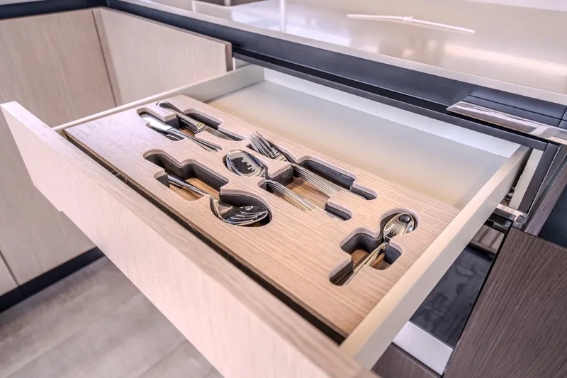 Slide: The Image of Open kitchen drawer with organized cutlery in Absolute 48 Coupe, 2026 model. - 34