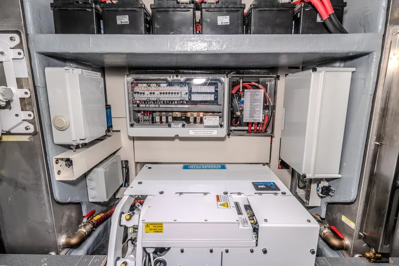 Slide: The Image of Electrical system of 2026 Absolute 48 Coupe yacht, featuring batteries and control panels. - 53