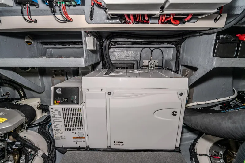 Slide: The Image of Engine room of 2026 Absolute 48 Coupe with Onan marine generator and wiring. - 56