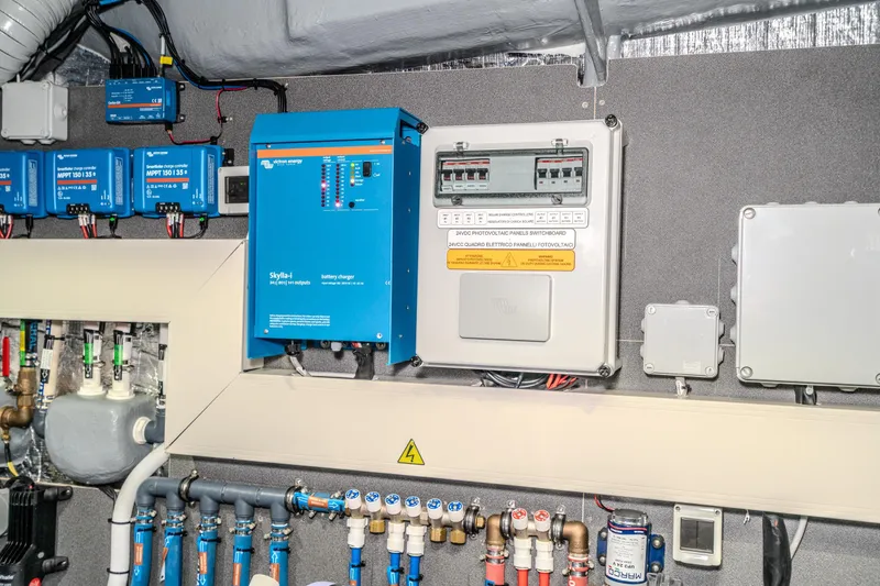 Slide: The Image of Electrical system of 2026 Absolute 48 Coupe yacht with battery charger and control panels. - 60