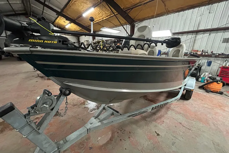 The Image of 2003 Lund 1650 Explorer SS boat on a trailer, parked outdoors. - 0