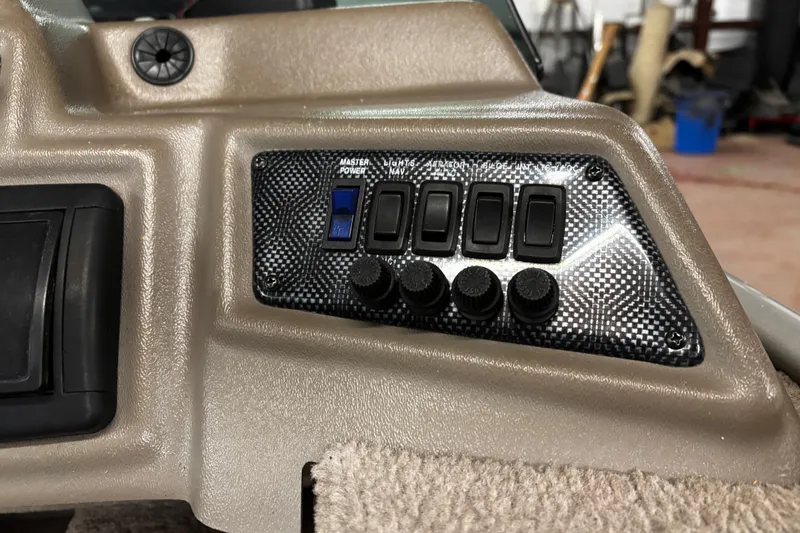 Slide: The Image of 2003 Lund 1650 Explorer SS boat on trailer, parked outdoors, featuring a trolling motor. - 13