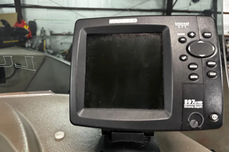 Slide: The Image of 2003 Lund 1650 Explorer SS boat interior with gray seats and carpeted flooring. - 14