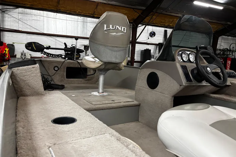 Slide: The Image of 2003 Lund 1650 Explorer SS boat interior with branded seats in a garage setting. - 16
