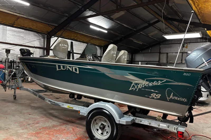 Slide: The Image of Control panel of a 2003 Lund 1650 Explorer SS boat with switches and knobs. - 17