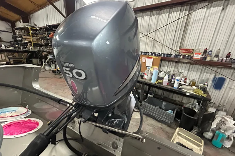 Slide: The Image of 2003 Lund 1650 Explorer SS boat on trailer in a garage setting. - 2