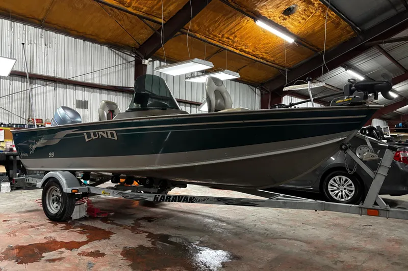 Slide: The Image of 2003 Lund 1650 Explorer SS boat interior with steering console and seating. - 20